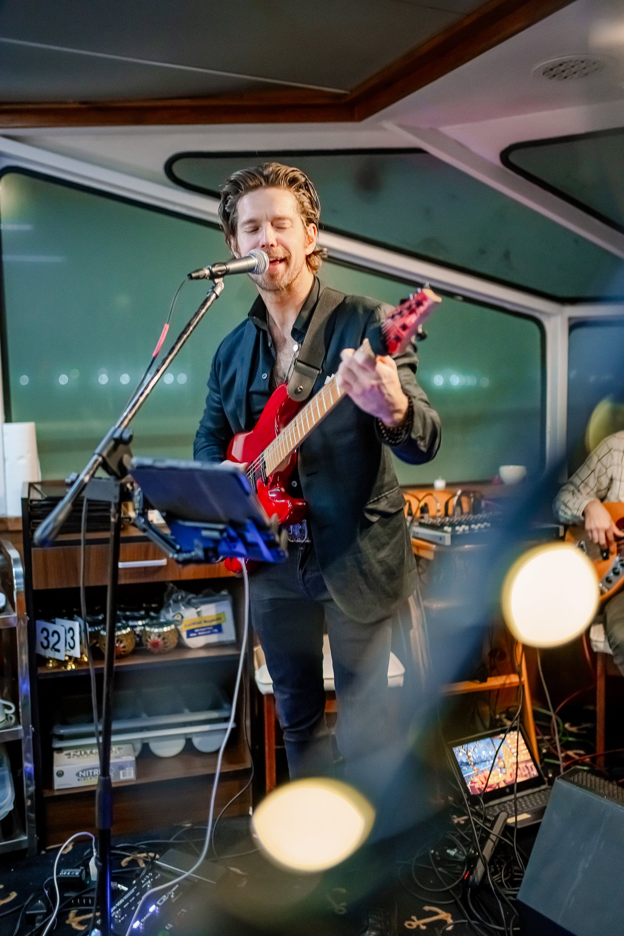 A guitarist performing live aboard the vessel during dinner service